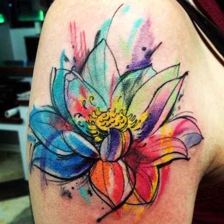 A flower tattoo done in watercolor style