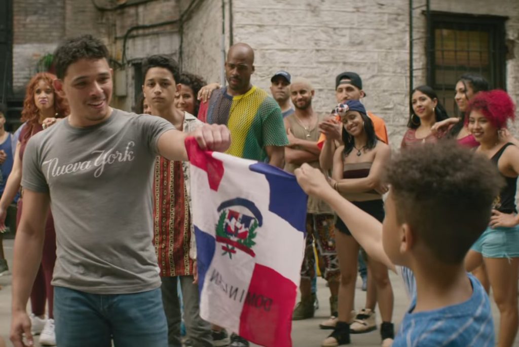 Image from the film of Usnavi holding a Dominican Republic flag.